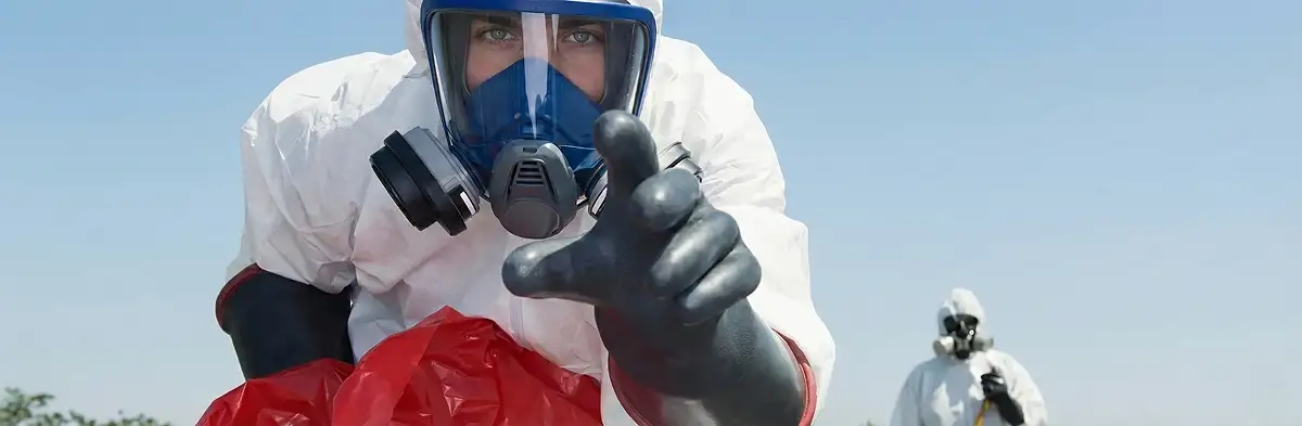 sewage clean up technician wearing protective gear handling biohazard materials in Wilmington, NC