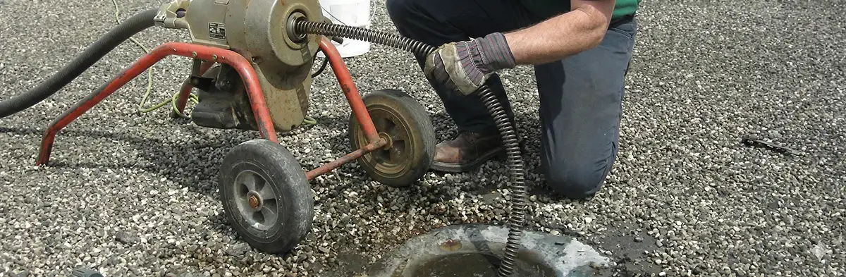 sewer rodding technician actively removing blockages from a sewer line in Wilmington, NC