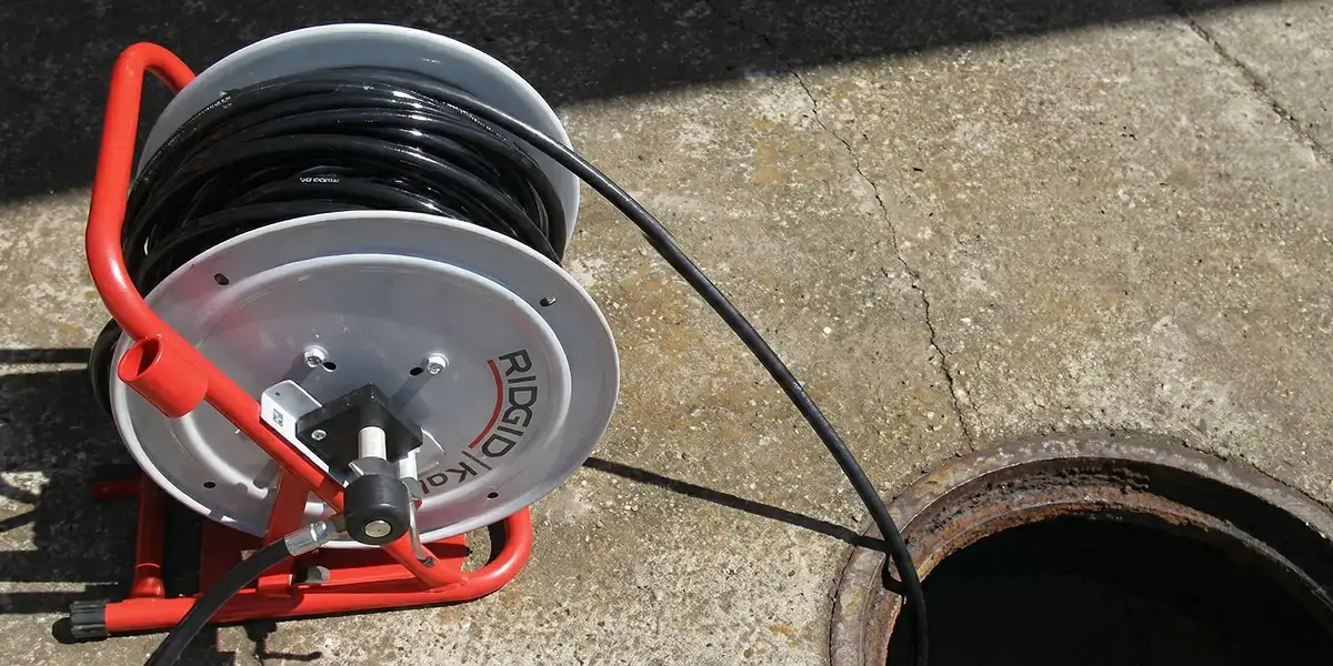 sewer rodding equipment prepared to clear clogged sewer lines in Wilmington, NC